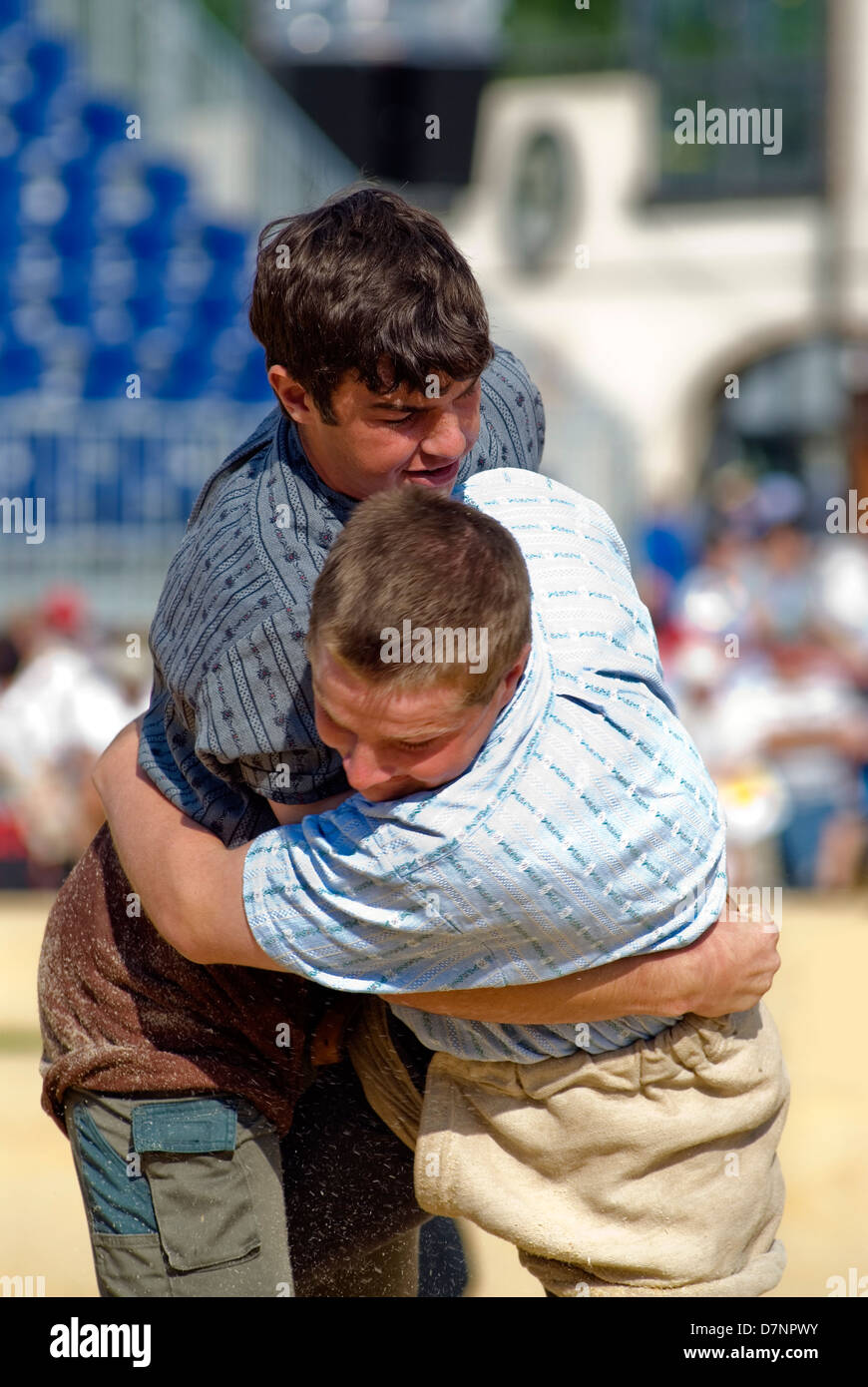 Schwingen (Swiss wrestling) at folklore festival, with spectators in background Stock Photo