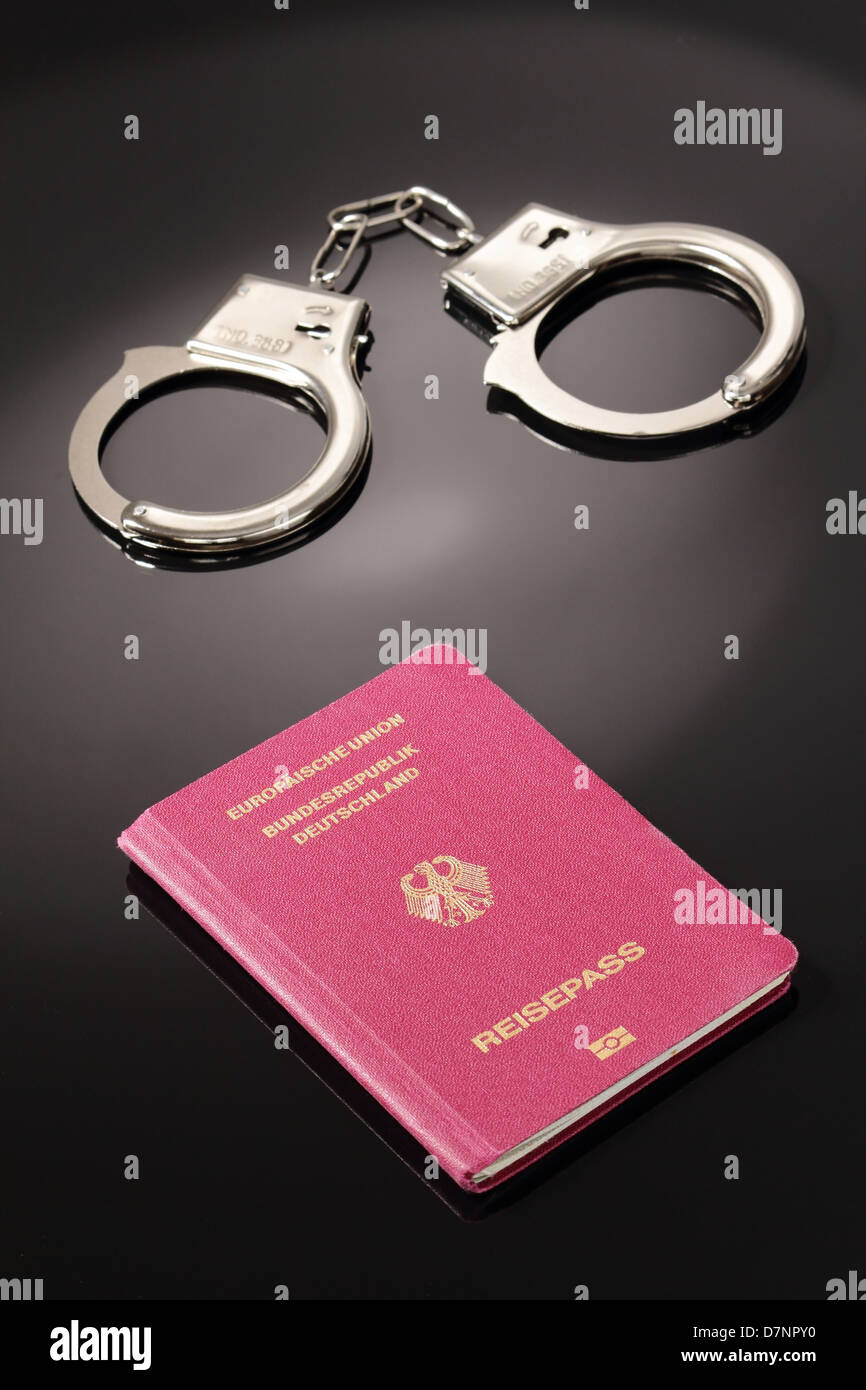 Passport with handcuffs Stock Photo