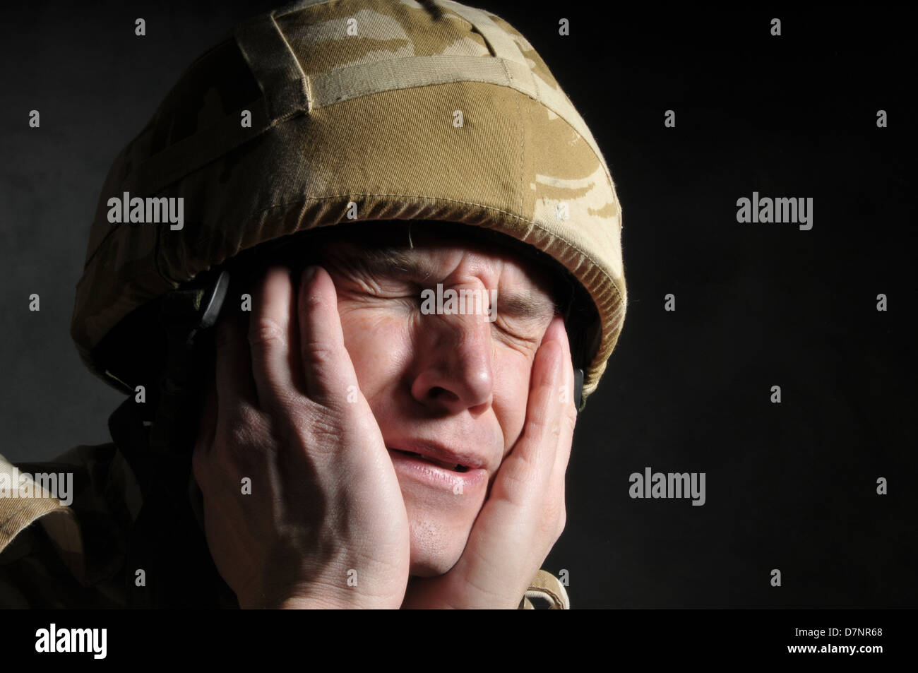 British soldier suffering from shell shock/PTSD, against a black background. Stock Photo