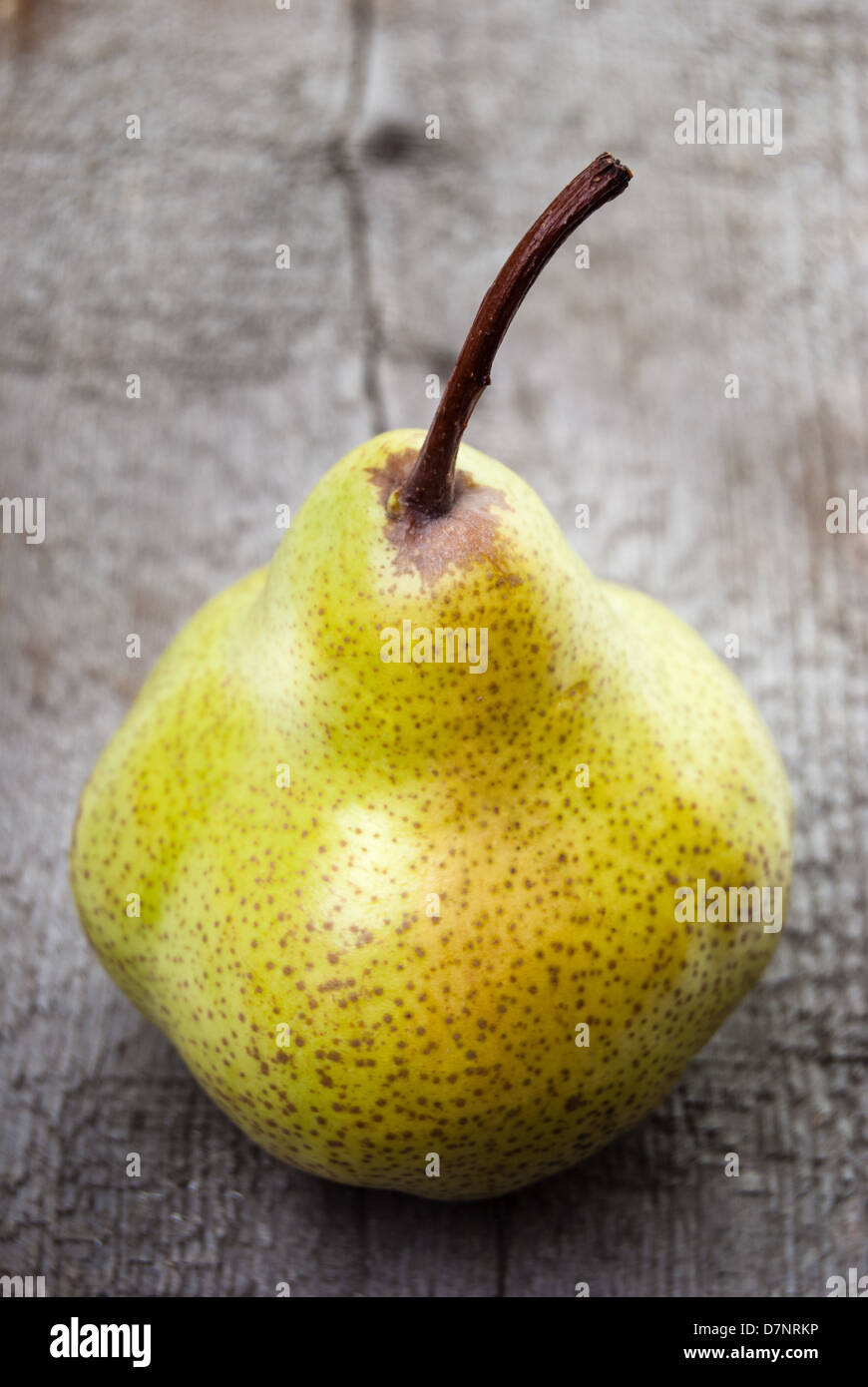 Yellow duchesse pear on wooden surface Stock Photo