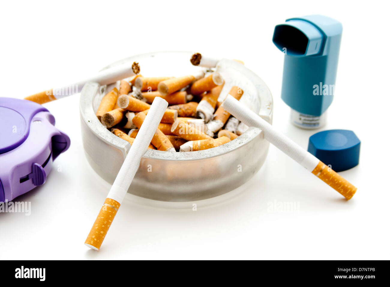Full ashtray with asthma spray Stock Photo