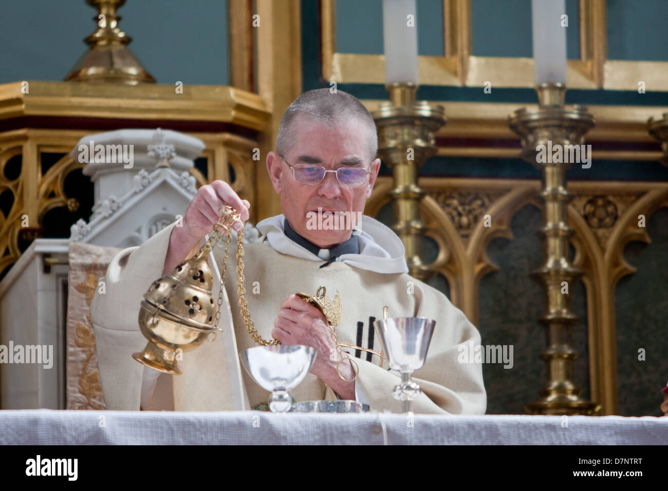 A Catholic priest with a thurible Stock Photo