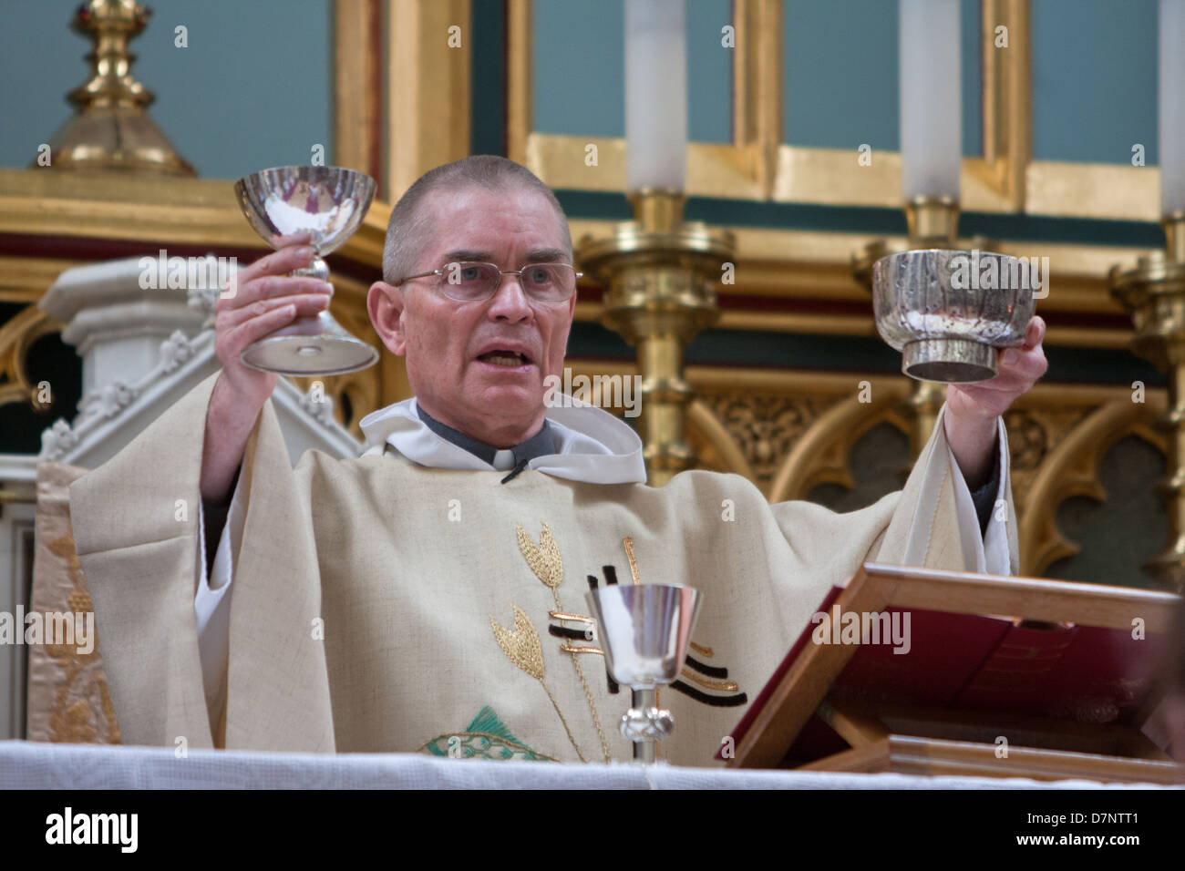 A Catholic priest celebrates mass Stock Photo