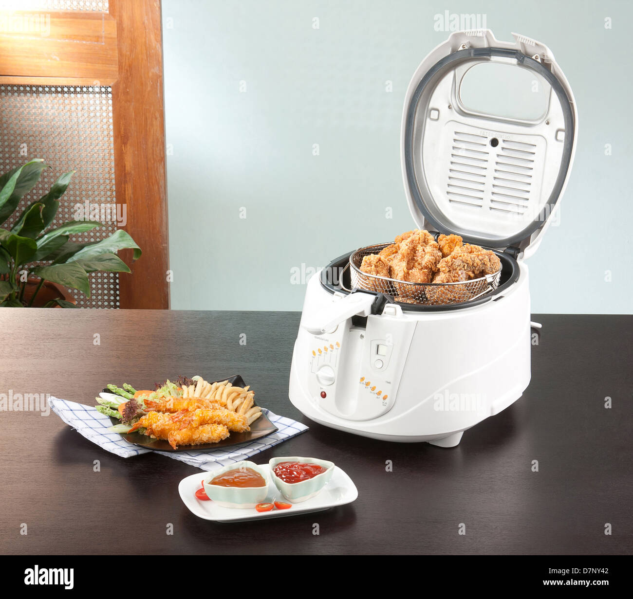 Let's do your chicken fried by using deep fryer machine comfortable and fast Stock Photo
