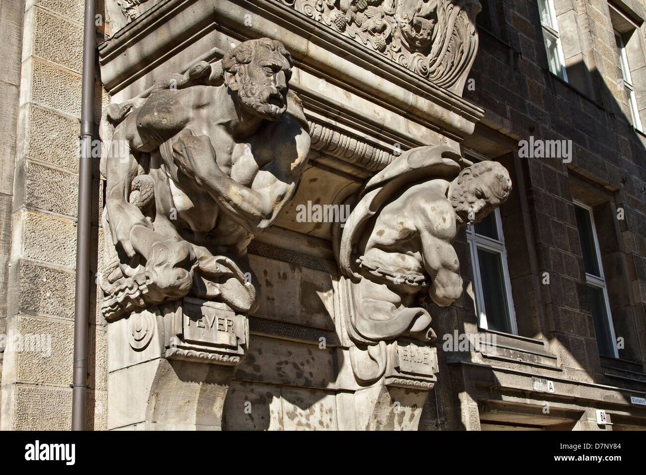 Two busts called Fever & Erde supporting an enclosed walkway between two buildings in Fransoschestraße, Berlin. Stock Photo