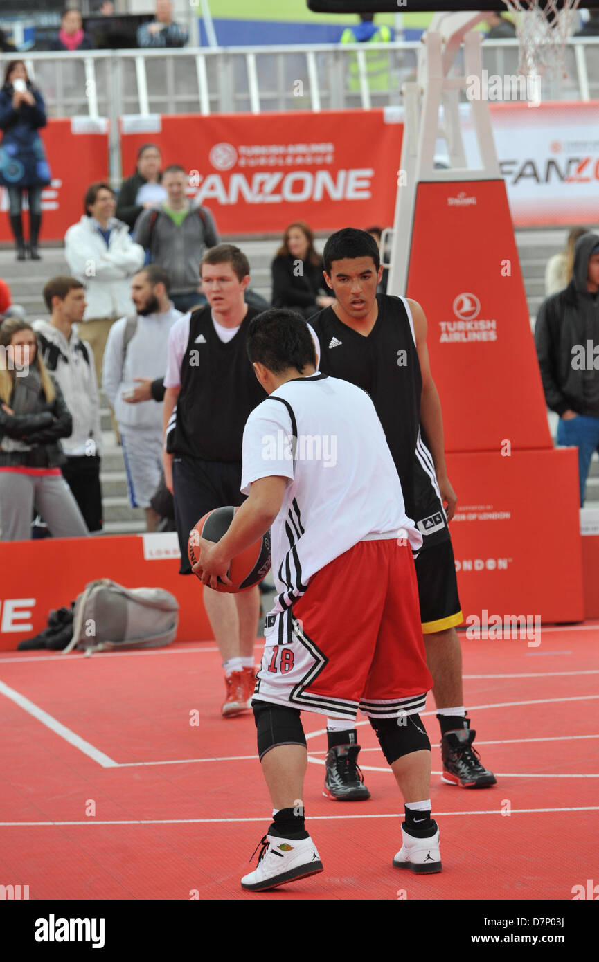 Trafalgar Square, London, UK. 11th May 2013. Players on the baskeball court in the centre of Trafalgar Square. The Turkish Airlines Euroleague Basketball Fan Zone fills more than 2,000 square meters of Trafalgar Square with activities throughout Final Four weekend from Friday, May 10 to Sunday, May 12. A weather-proof Main Court, two full courts complete with a 15-meter-high roof, in the middle of the square. The Turkish Airlines Main Court will be the main venue for games, contests and other activities. Credit:Matthew Chattle/Alamy Stock Photo