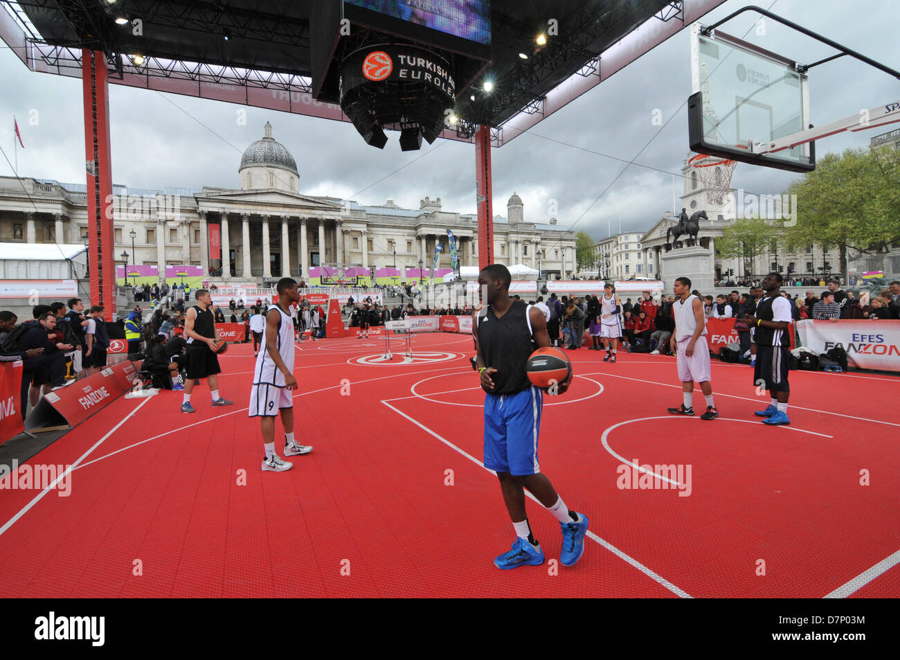 Trafalgar Square, London, UK. 11th May 2013. Players on the baskeball court in the centre of Trafalgar Square. The Turkish Airlines Euroleague Basketball Fan Zone fills more than 2,000 square meters of Trafalgar Square with activities throughout Final Four weekend from Friday, May 10 to Sunday, May 12. A weather-proof Main Court, two full courts complete with a 15-meter-high roof, in the middle of the square. The Turkish Airlines Main Court will be the main venue for games, contests and other activities. Credit:Matthew Chattle/Alamy Stock Photo