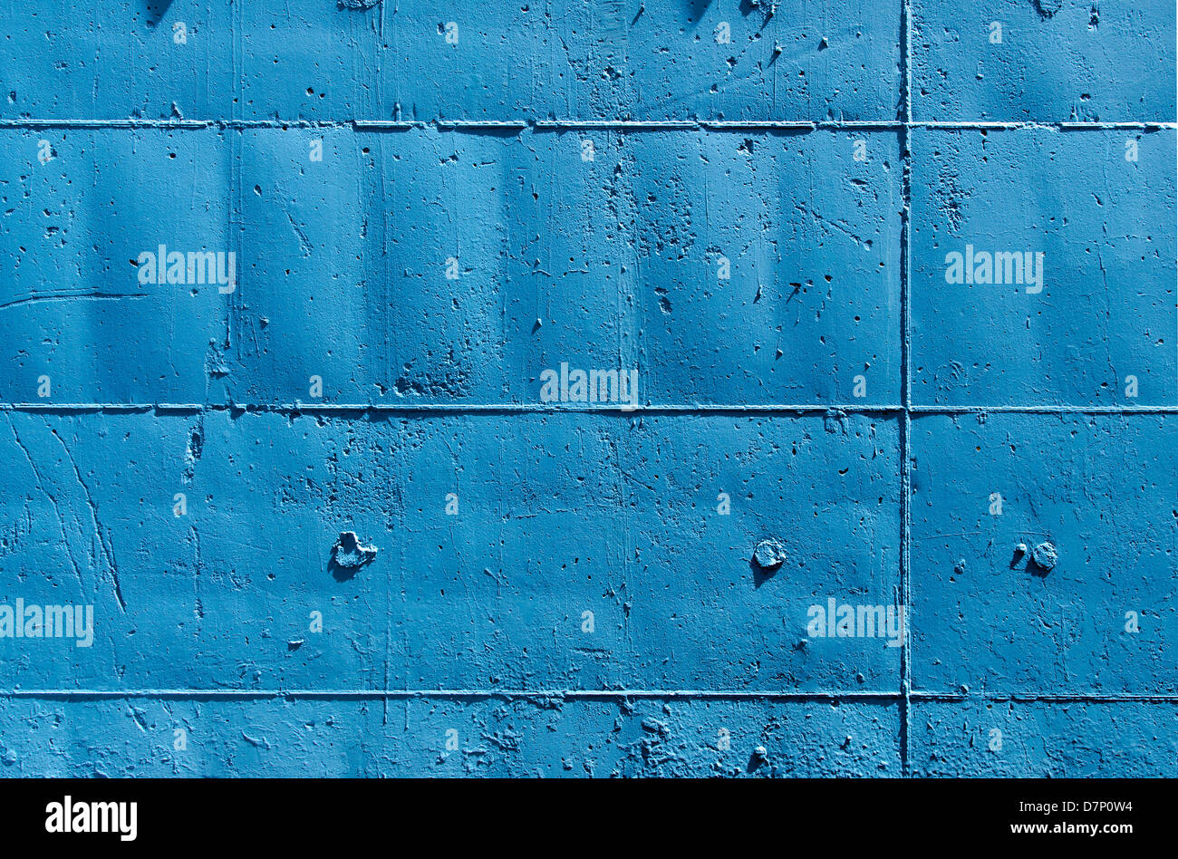 Blue tinted outer wall, with signs on the surface of the molds that were used in their construction Stock Photo