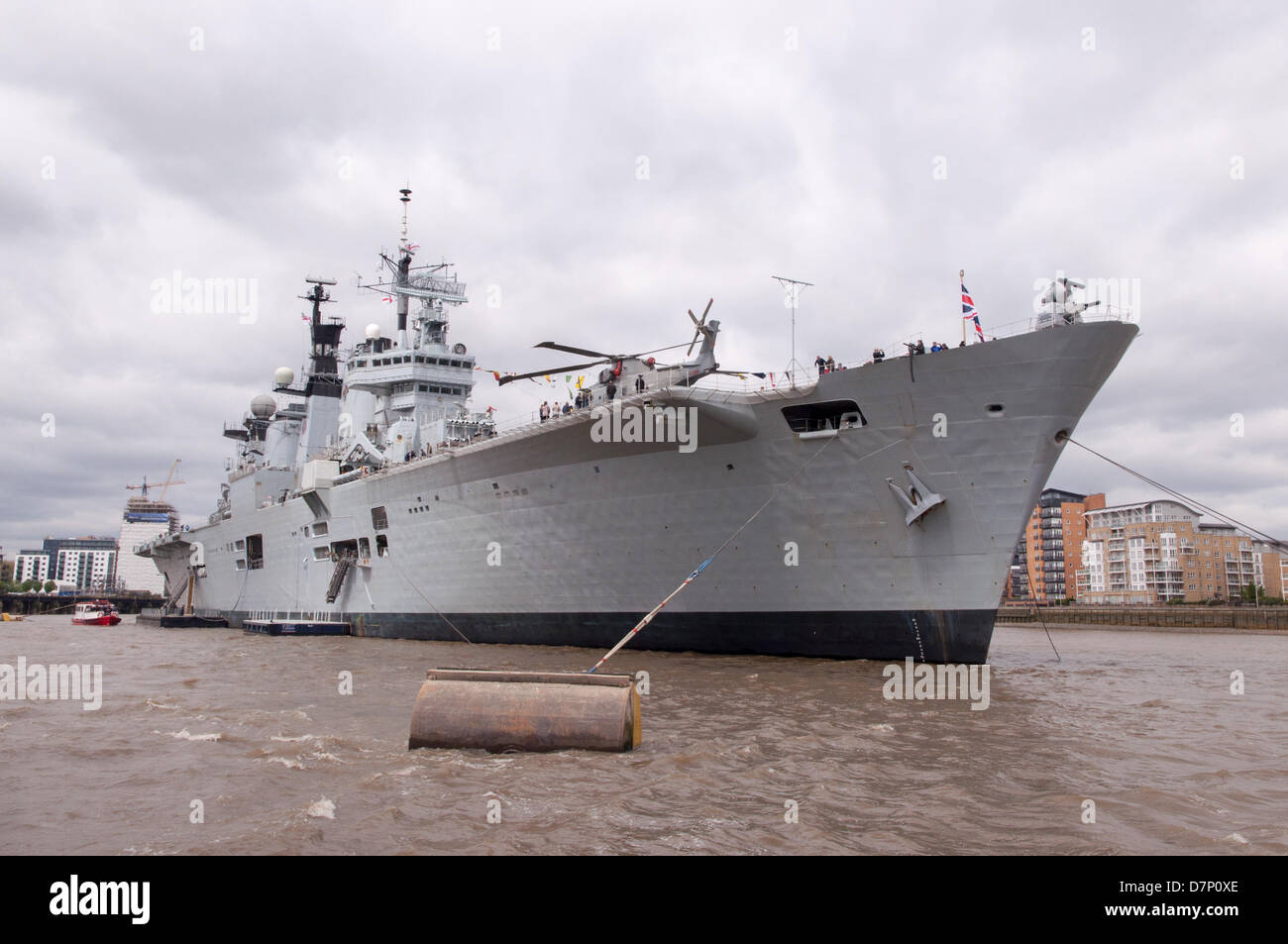 The River Thames, nr Greenwich, London, UK. 11th May 2013. HMS Illustrious, the Royal Navy's helicopter and Commando carrier, visiting London to commemorate the 70th anniversary of the 'Battle of the Atlantic'. Moored on the River Thames next to Greenwich on Saturday 11th May 2013. Credit: Craig Buchanan /Alamy Live News Stock Photo