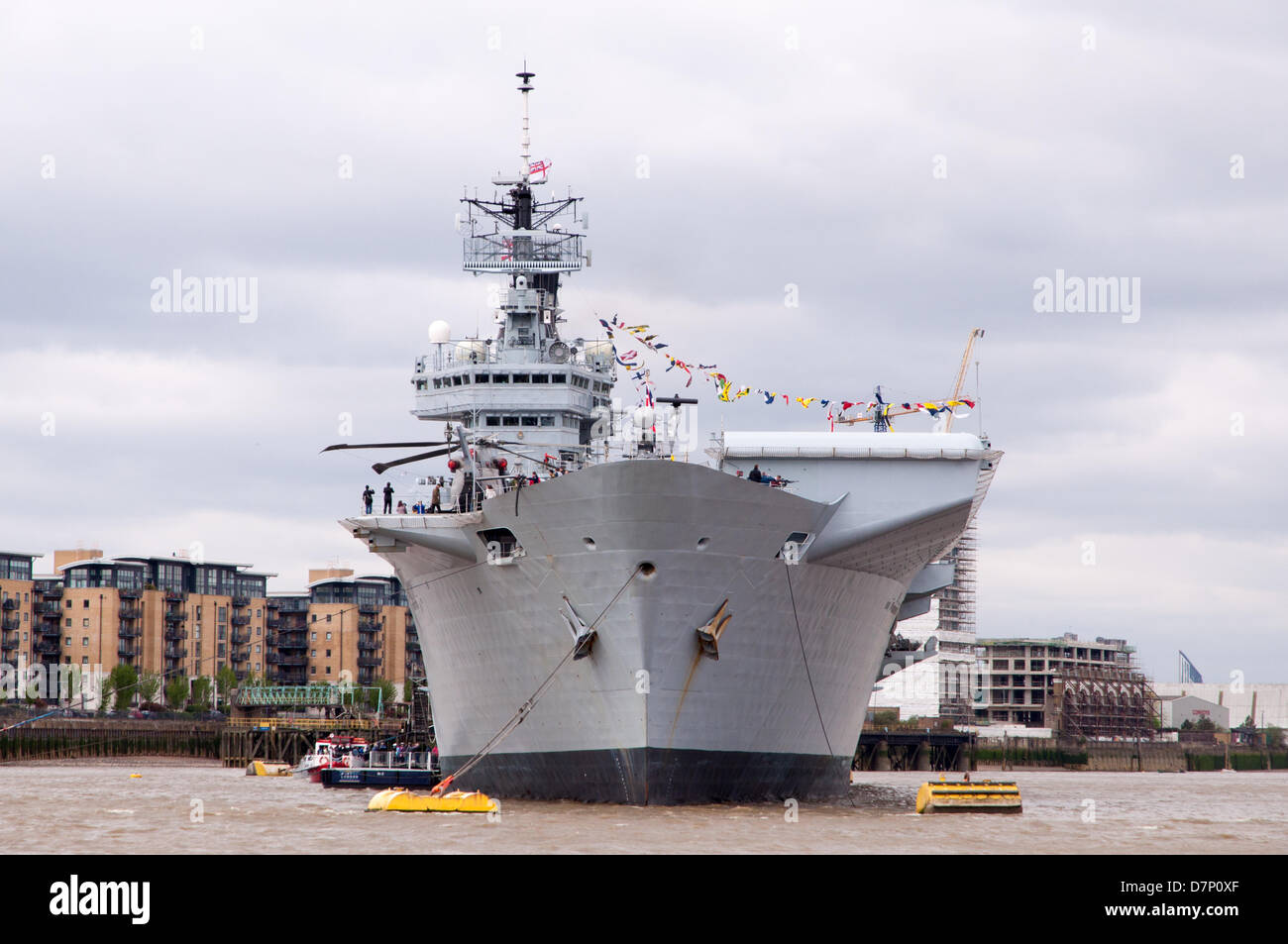 The River Thames, nr Greenwich, London, UK. 11th May 2013. HMS Illustrious, the Royal Navy's helicopter and Commando carrier, visiting London to commemorate the 70th anniversary of the 'Battle of the Atlantic'. Moored on the River Thames next to Greenwich on Saturday 11th May 2013. Credit: Craig Buchanan /Alamy Live News Stock Photo