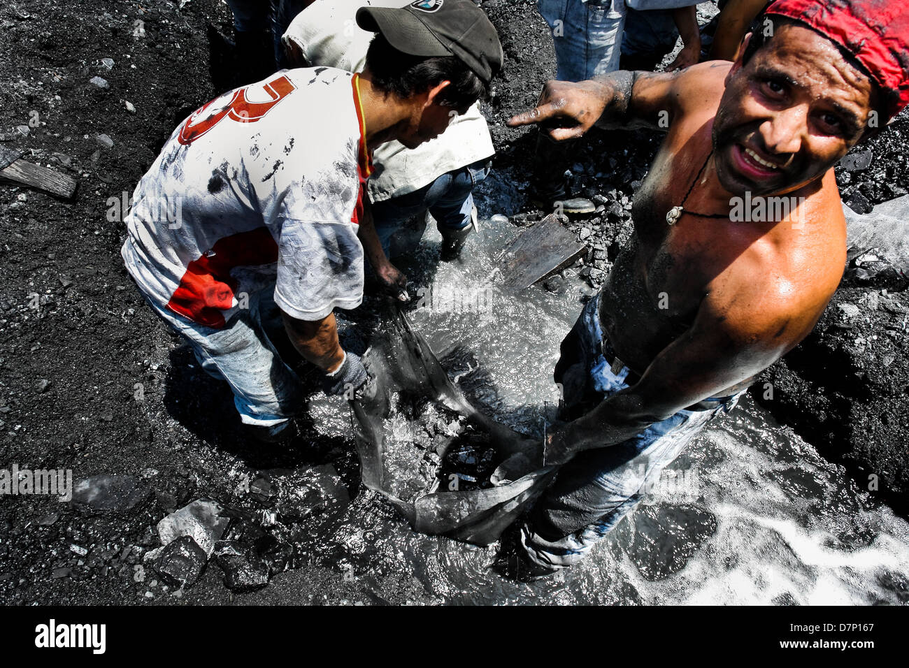 Miners Washing Miners wash the emerald containing mud in the mine of Muzo, Colombia ...