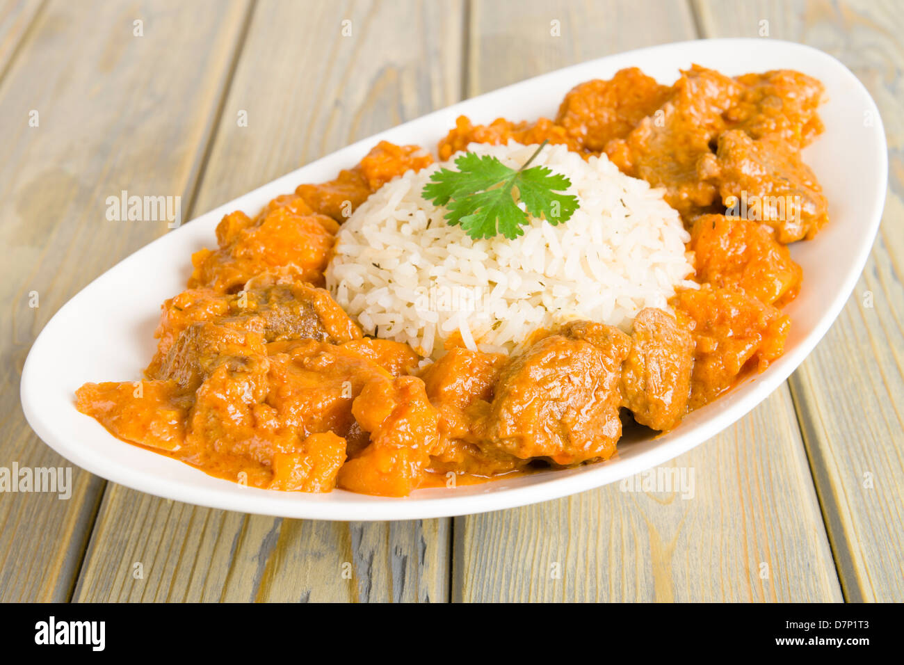Lamb and sweet potato peanut stew served with white rice. Caribbean and