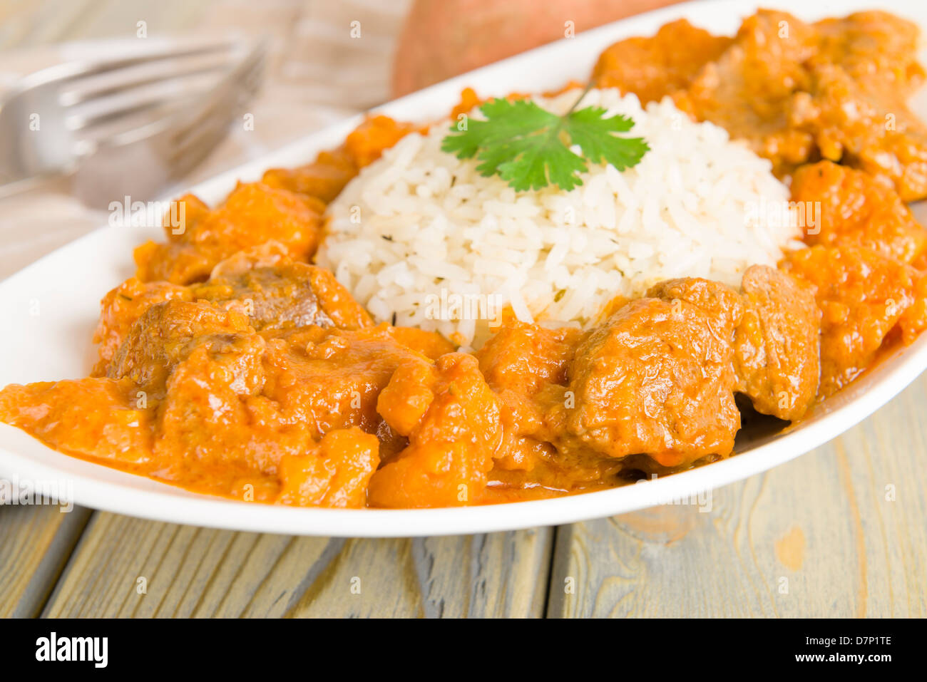 Lamb and sweet potato peanut stew served with white rice. Caribbean and