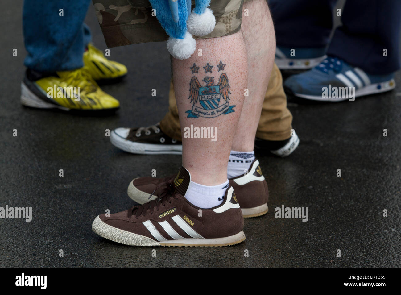 Wembley, London, UK. 11th May 2013. A football supporter with a tattoo of  the Manchester City team crest on his leg. Thousands of fans from greater  Manchester descend on Wembley stadium for