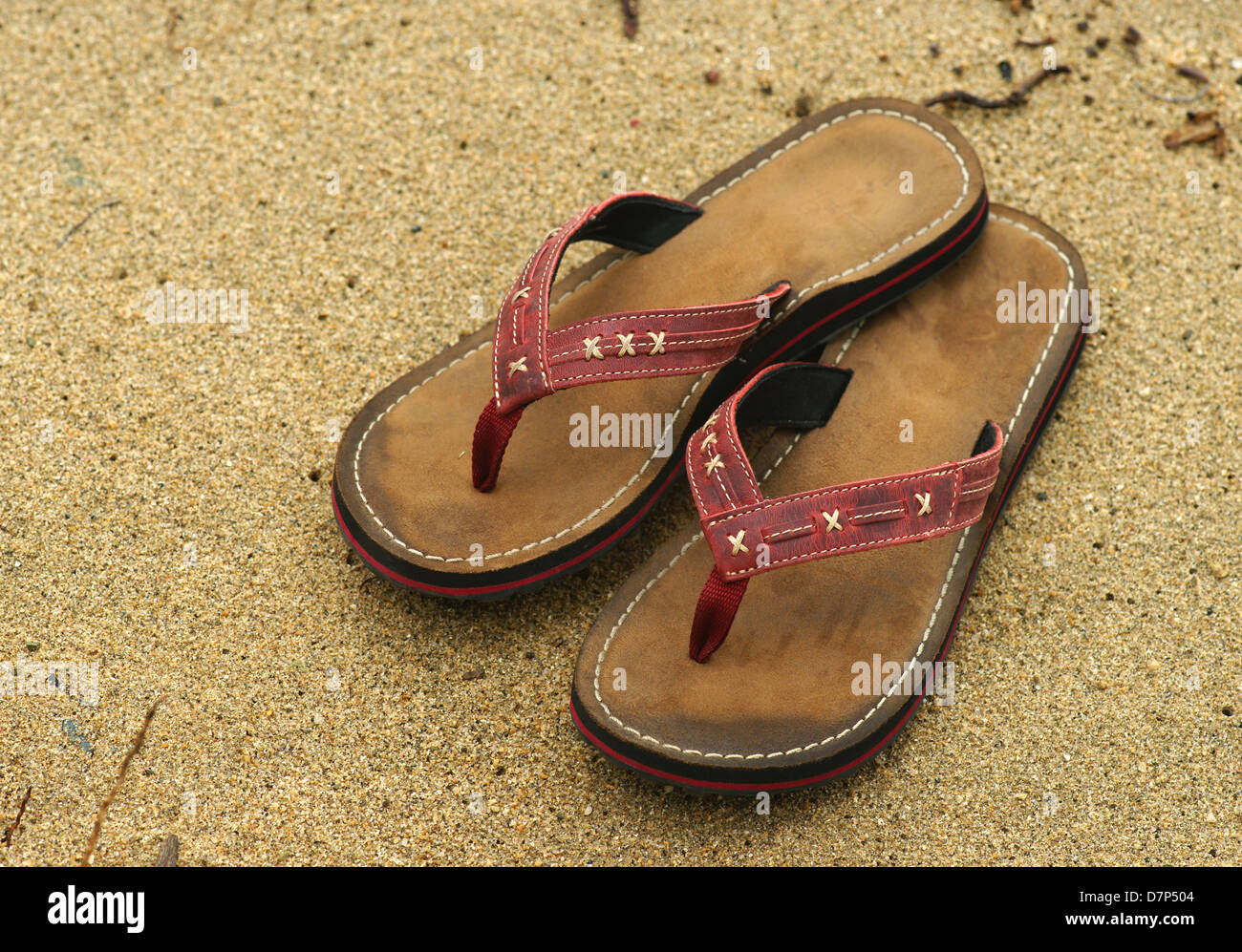 Flip flops left on a sandy beach. Stock Photo