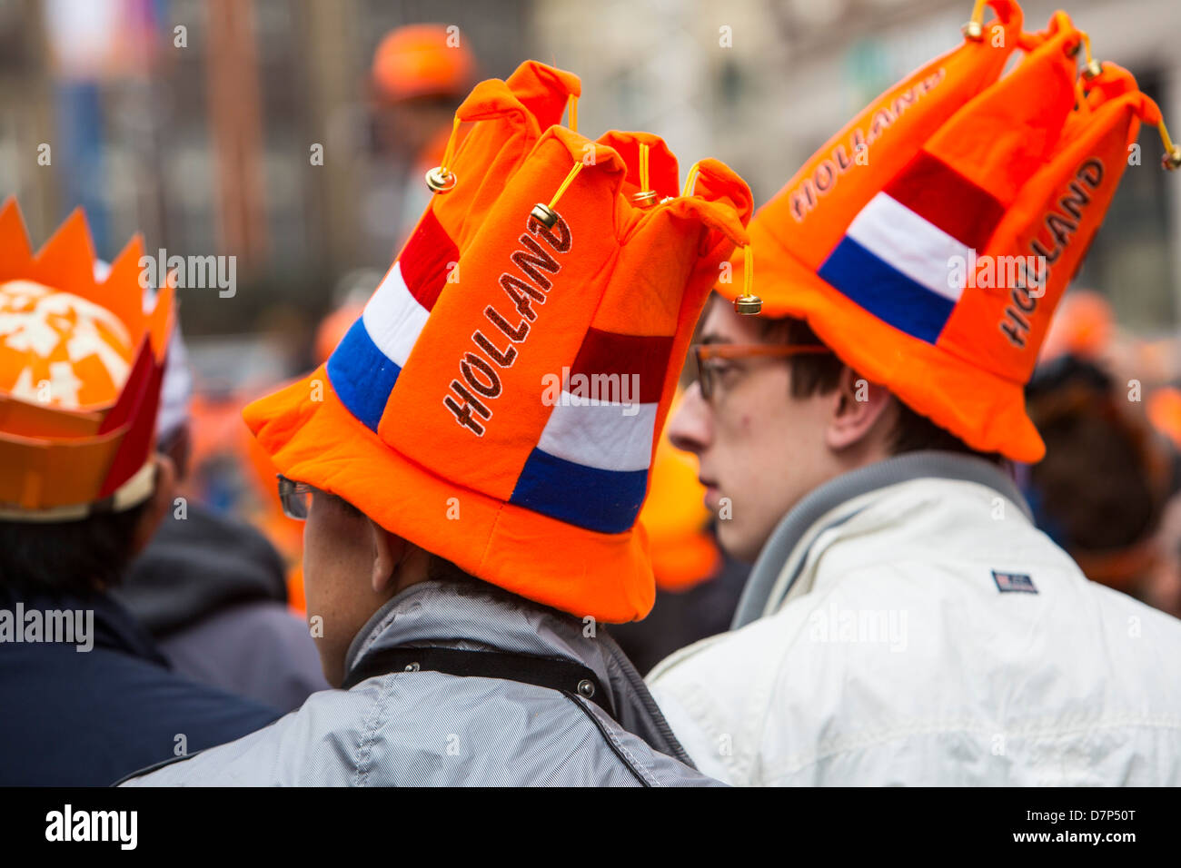 People celebrating annual  Queens day in the old town of Amsterdam. Stock Photo