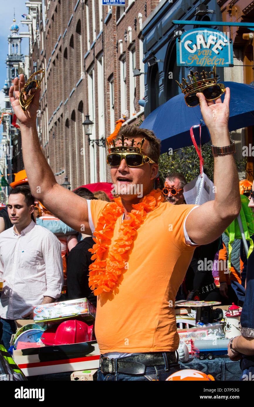 People celebrating annual  Queens day in the old town of Amsterdam. Stock Photo