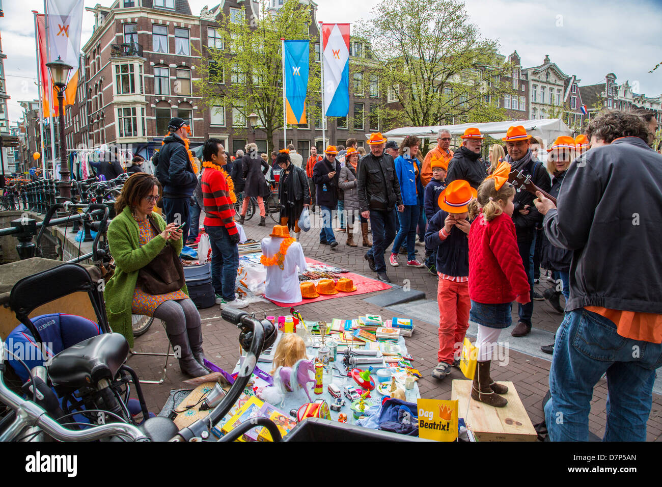 Celebrating Queens day in the Netherlands. Flee market stands in the old town of Amsterdam. Stock Photo