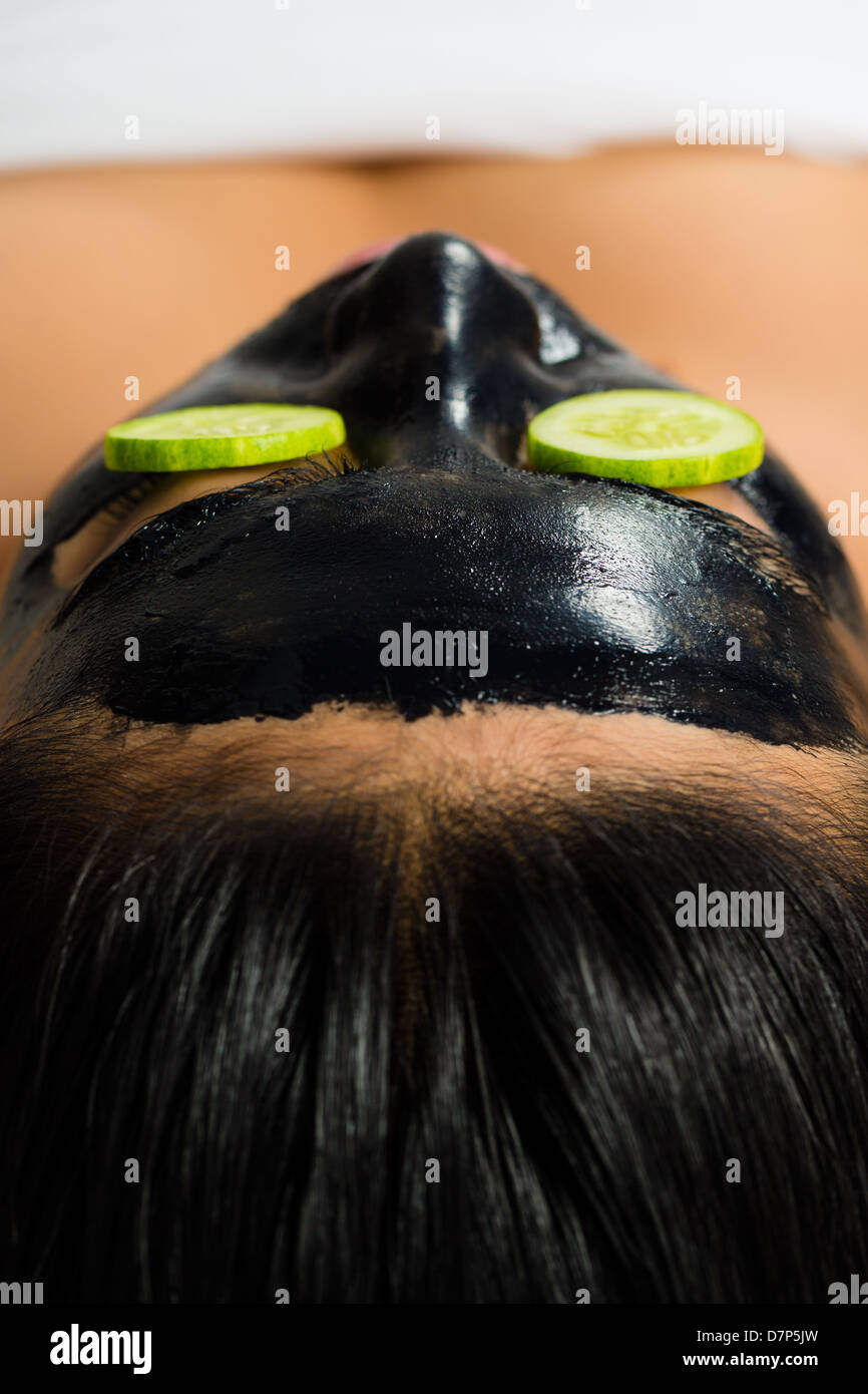 Young Asian Woman in a beauty spa getting a treatment with mask to bleach the skin Stock Photo