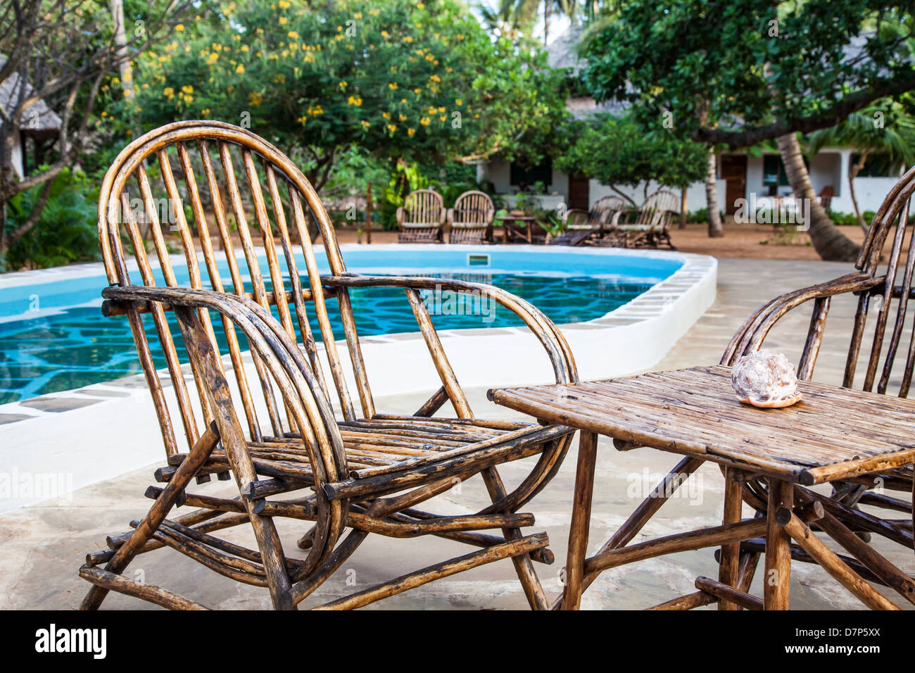 Elegant chairs made of wood close to a swimming pool inside a Kenyan garden Stock Photo Alamy