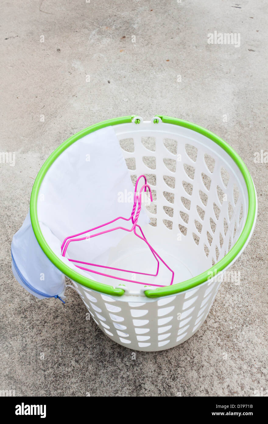 Cloth hanger and wash bag in plastic laundry basket Stock Photo Alamy