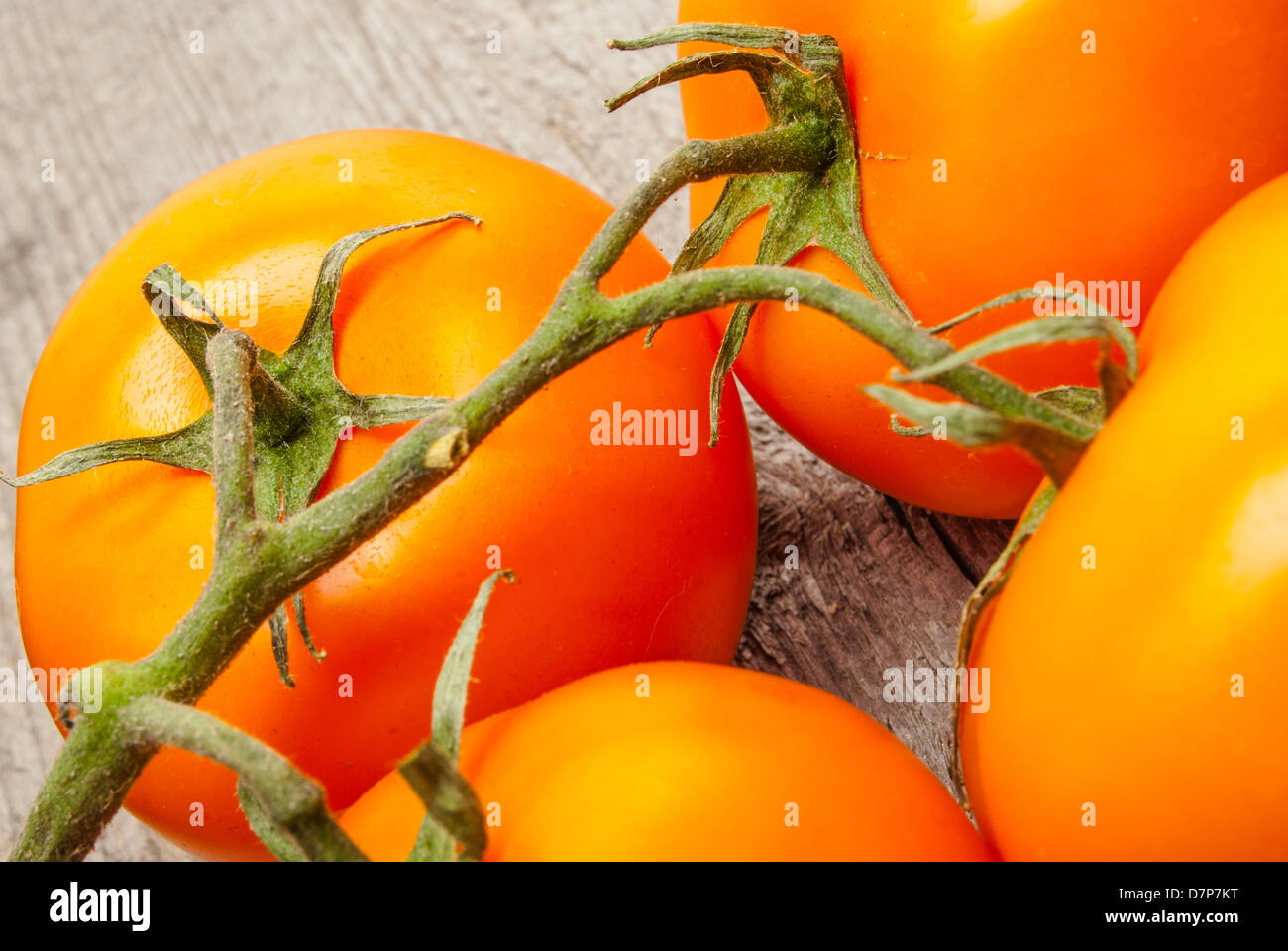 Fragment of Red tomatoes on a brunch wood Stock Photo