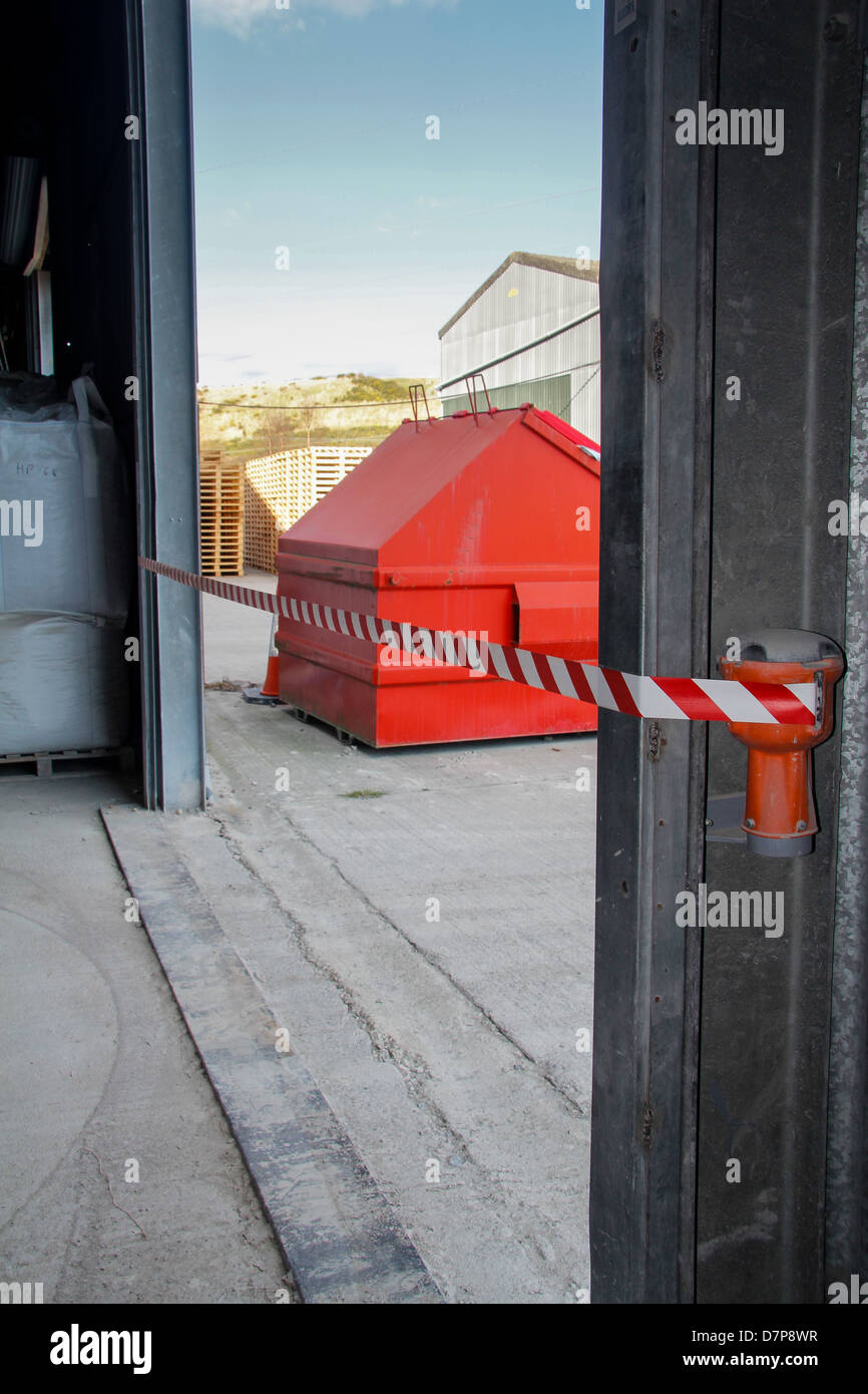 Tempory tape safety barrier across a factory door way Stock Photo Alamy