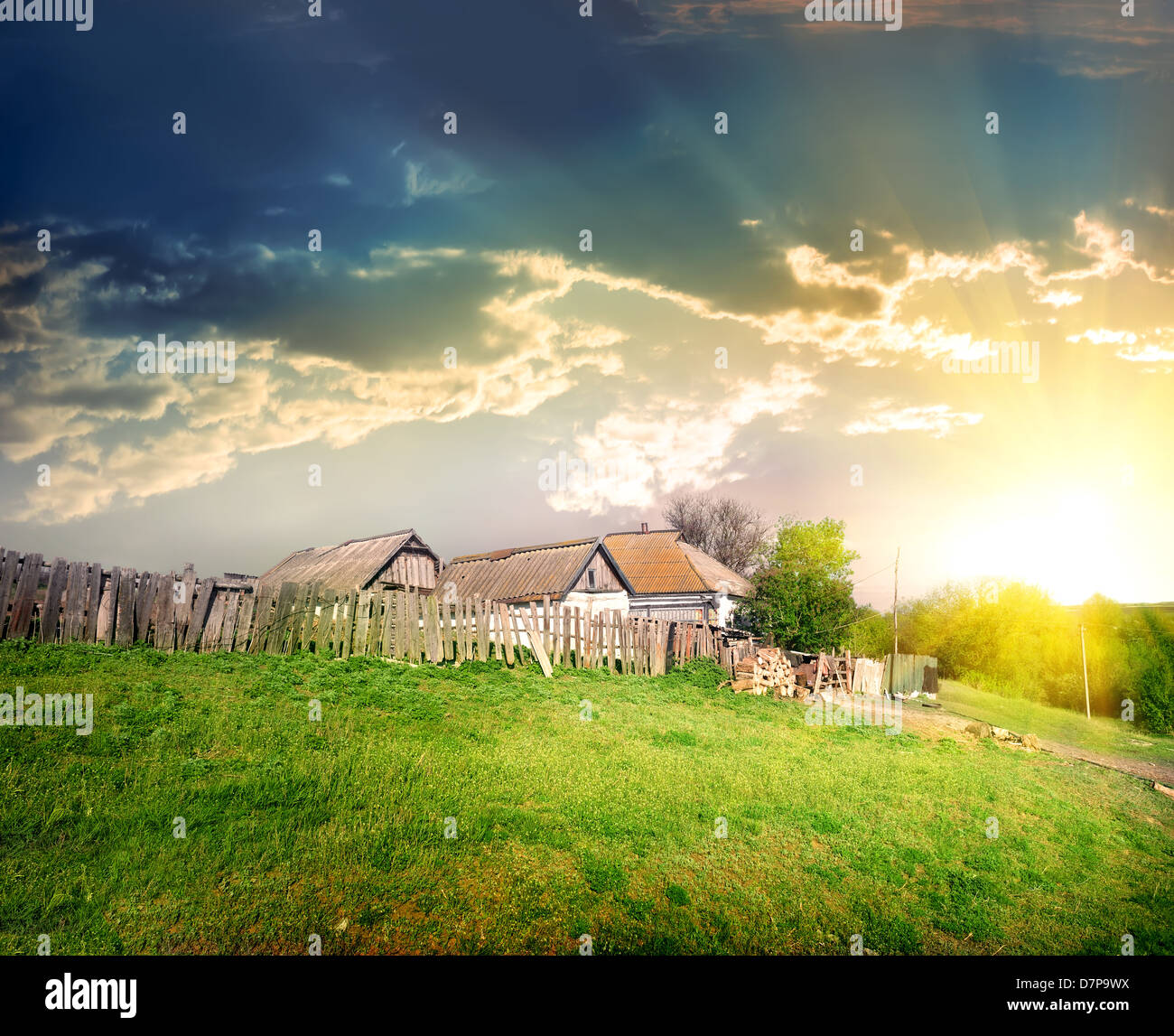 Old village house on the background of thunder clouds Stock Photo