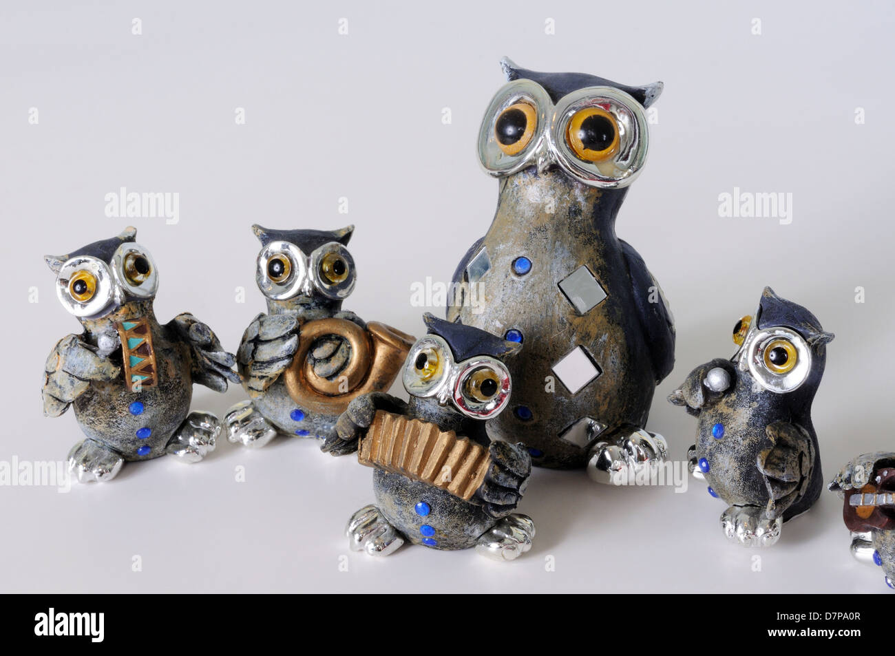 Owl musical band ornaments against a plain background Stock Photo Alamy