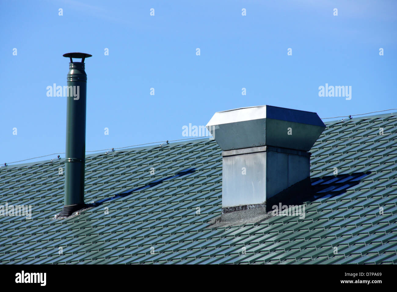 Pipe of ventilation are located on a roof of a building Stock Photo