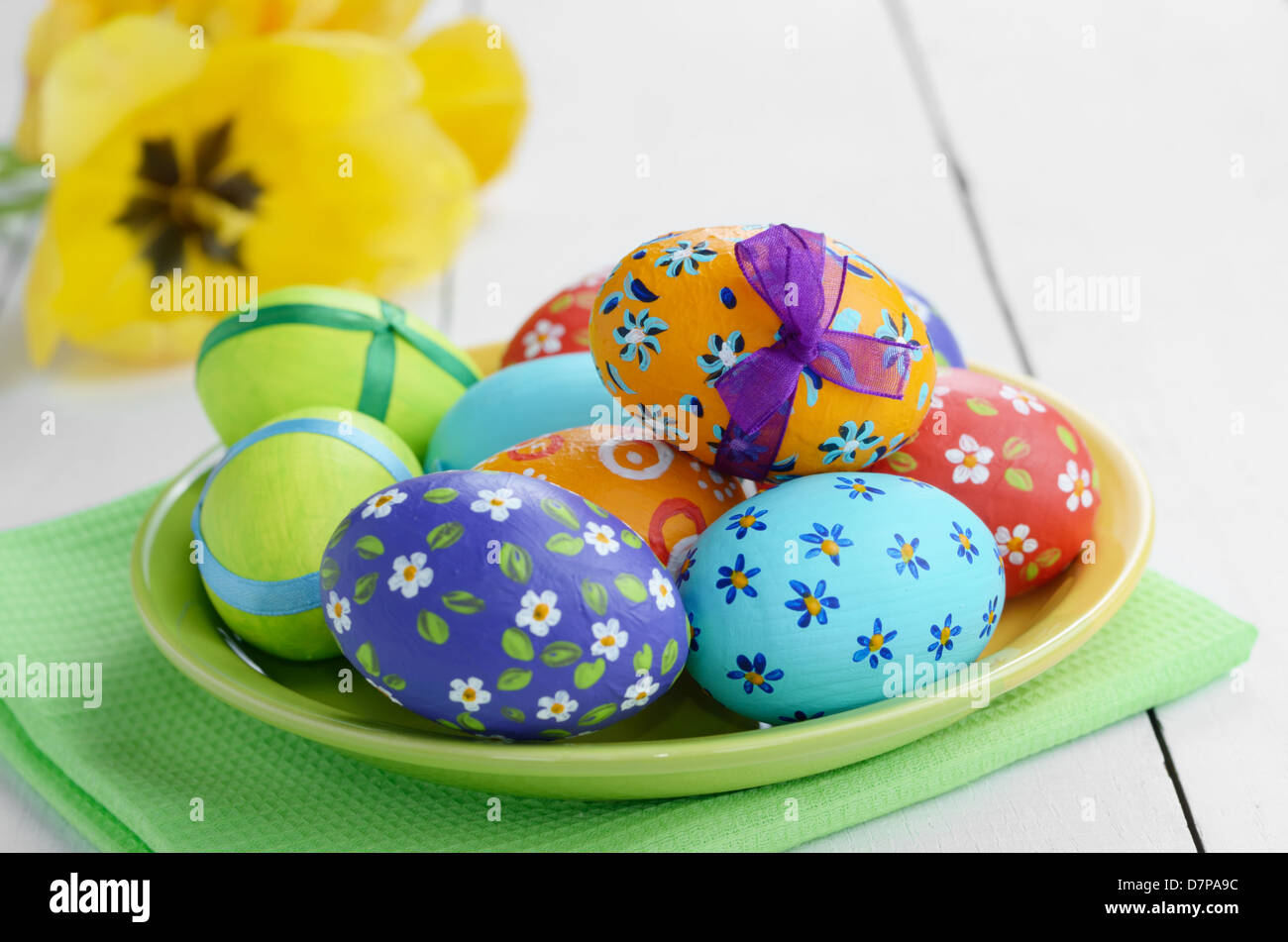 Easter eggs with painted flowers on white table Stock Photo