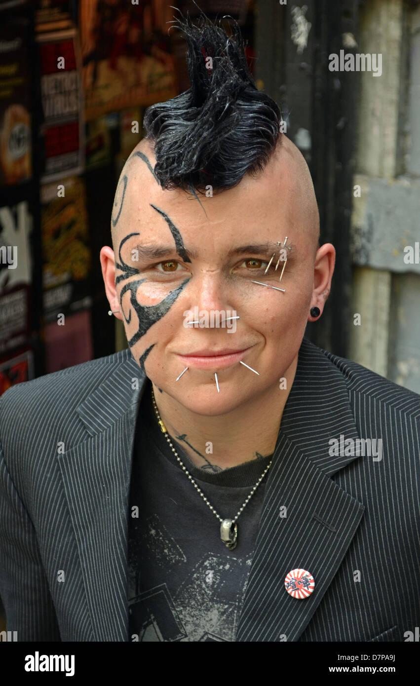 Portrait in Greenwich Village with a Mohawk hairdo, face tattoo and multiple piercings Stock Photo