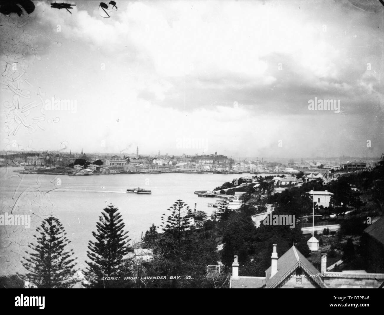 This photograph shows a view of Sydney from Lavender Bay, looking toward McMahons Point and the Powerhouse Museum. The scene captures the dramatic stormy weather and the boats in the harbor, offering a striking contrast between the natural elements and the cityscape. Stock Photo