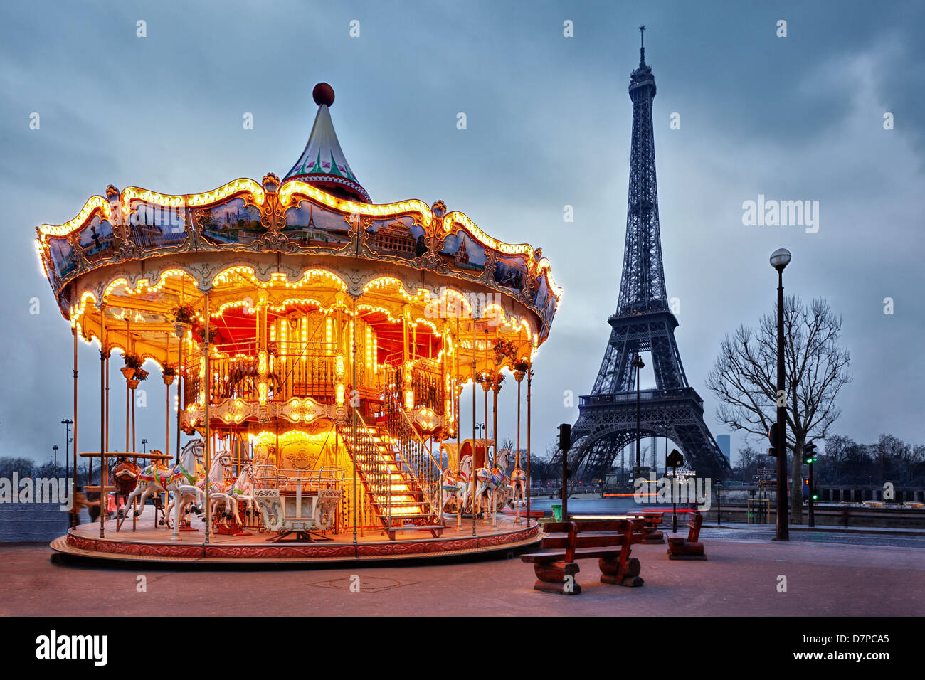 illuminated vintage carousel close to Eiffel Tower, Paris Stock Photo