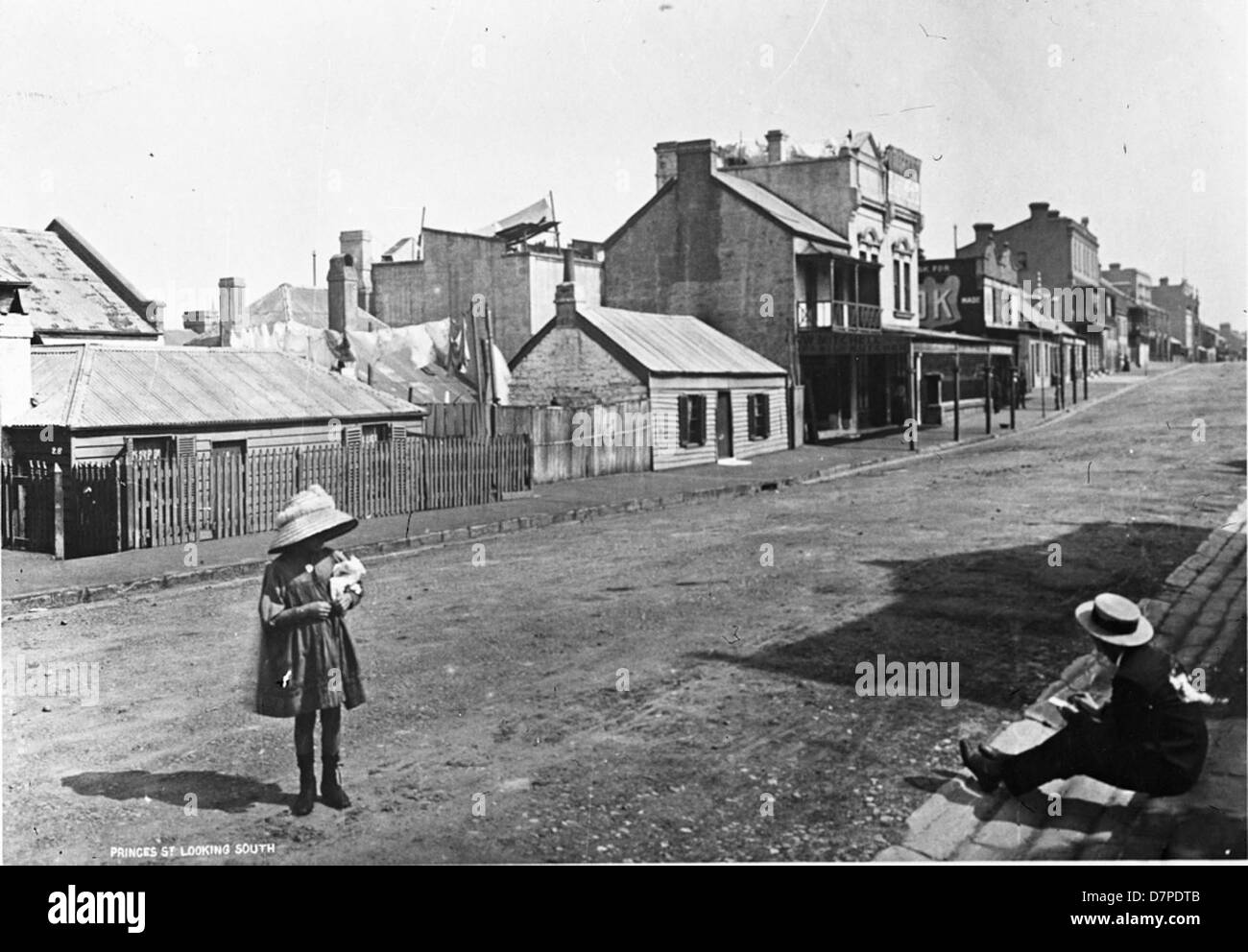 This black-and-white photograph shows Princes Lane in The Rocks, Australia, capturing a street scene from the early 20th century. The image highlights the architecture and daily life in the area during that period. Stock Photo