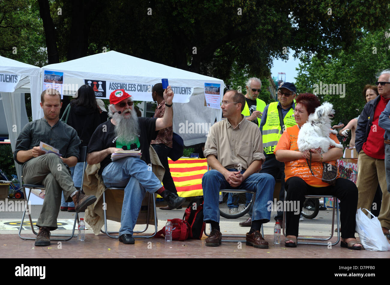 Barcelona, Spain. 12th May 2013. Second anniversary of '15-M' (15th May 2010) when Catalunya square of Barcelona was occupied by 'indignados' (people against budget cuts). This evening would be a great demonstration in the streets. In the image, speakers from left to right: Marco Aparicio (professor of constitutional law), Víctor Ríos (historian), Manel Montsonís (constituent) and woman with a dog. Fco Javier Rivas Martín/Alamy Live News Stock Photo