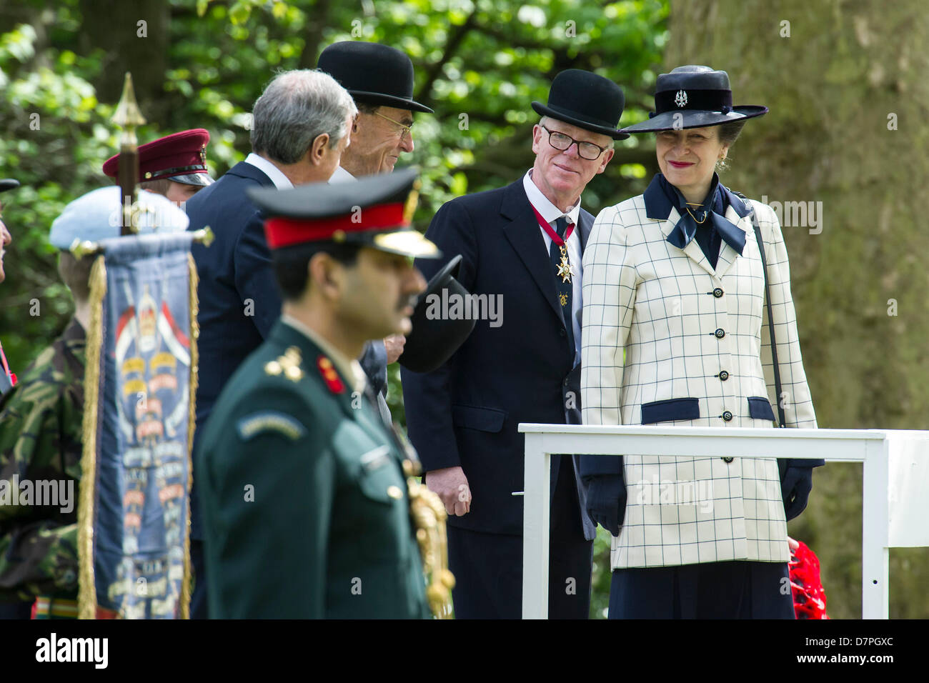 Hyde Park, London, UK 12 may 2013. Her Royal Highness The Princess Royal KG, KT, GCVO, Colonel in Chief The King’s Royal Hussars takes the salute and lays a wreath at the Annual Parade and Service of The Combined Cavalry Old Comrades Association at the Cavalry Memorial. Officers wear bowler hats and suits are worn instead of uniform by all but the bands.  5 bands led marching detachments of the Cavalry and Yeomanry Regimental Associations and Veterans ranging from World War 2 to Iraq and Afghanistan. State Trumpeters of the Household Cavalry and a Piper from F Company The Scots Guards also too Stock Photo