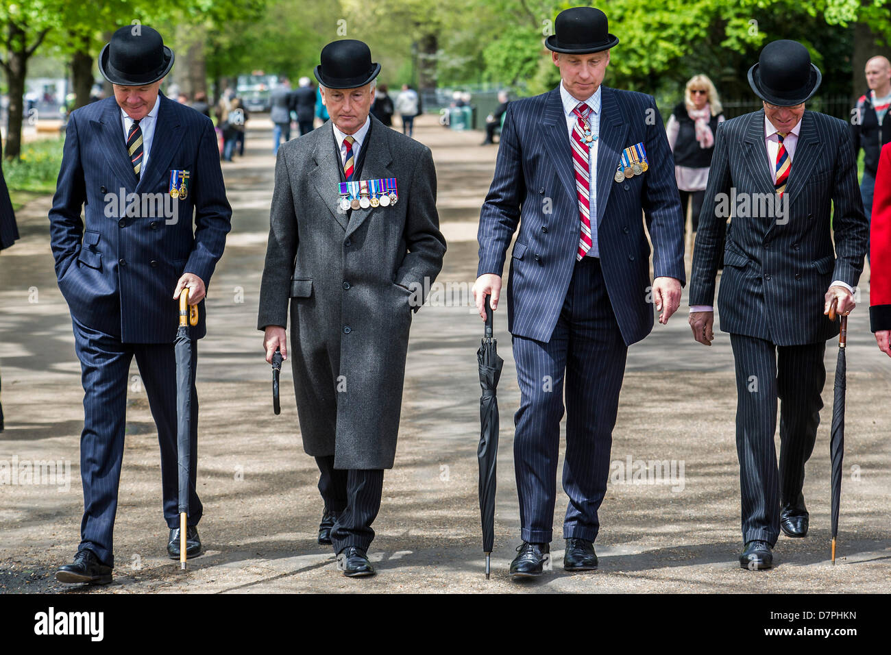 Hyde Park, London, UK 12 may 2013. Her Royal Highness The Princess Royal KG, KT, GCVO, Colonel in Chief The King’s Royal Hussars takes the salute and lays a wreath at the Annual Parade and Service of The Combined Cavalry Old Comrades Association at the Cavalry Memorial. Officers wear bowler hats and suits are worn instead of uniform by all but the bands.  5 bands led marching detachments of the Cavalry and Yeomanry Regimental Associations and Veterans ranging from World War 2 to Iraq and Afghanistan. State Trumpeters of the Household Cavalry and a Piper from F Company The Scots Guards also too Stock Photo