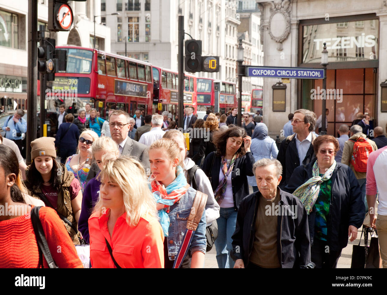 A crowd of pedestrians people crossing the road at Oxford Circus, central London, UK Stock Photo