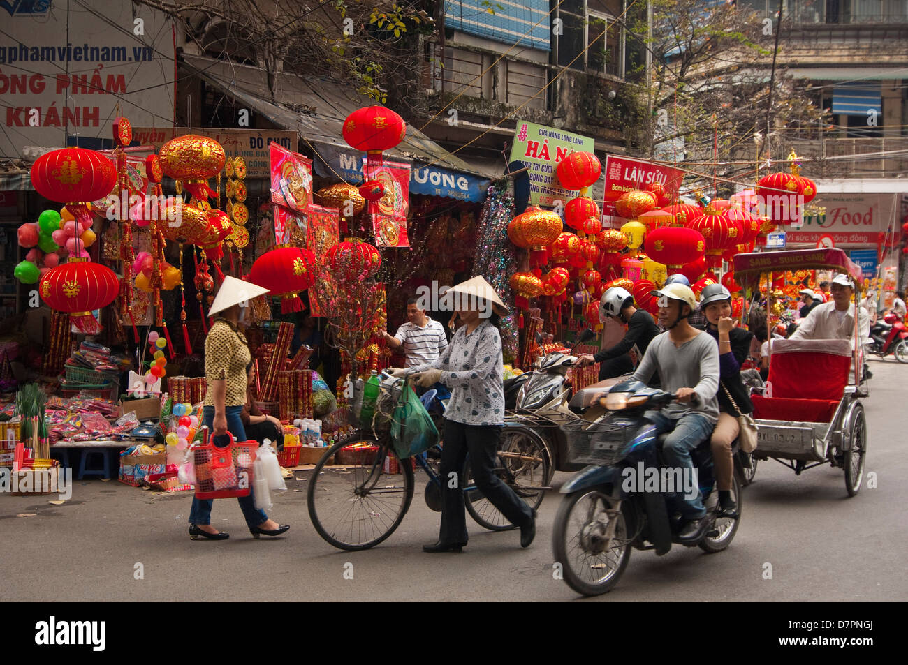 Horizontal streetscape of Chinese paper lanterns hanging outside a shop in the Old Quarter in preparation for Tet. Stock Photo