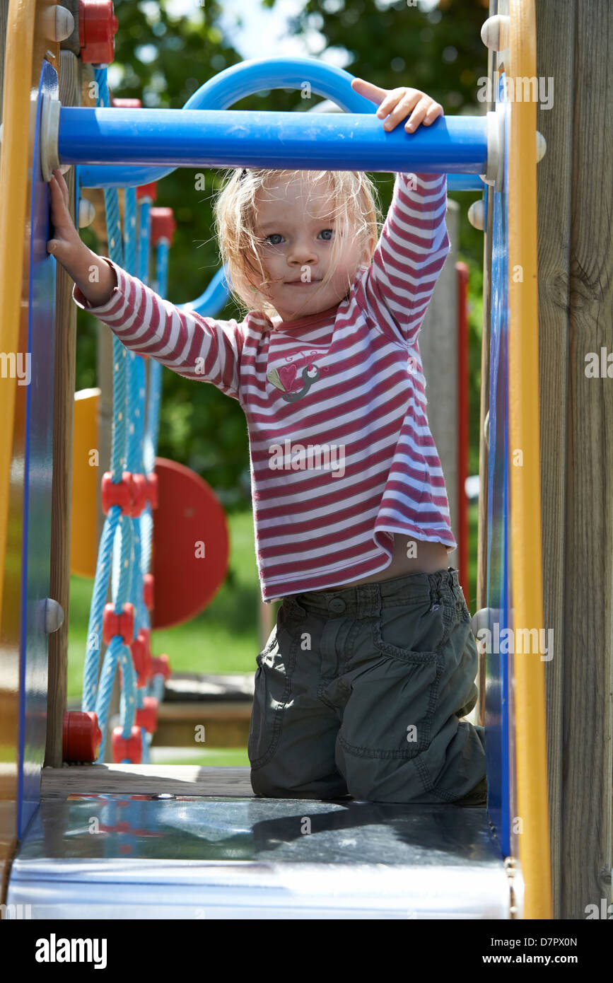 Child Blond Girl sliding slide on a playground Stock Photo Alamy