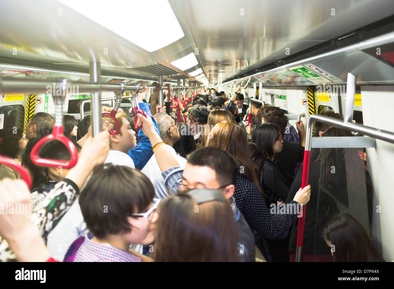 dh Mass transit railway MTR HONG KONG Crowd passengers commuter transport chinese busy underground train subway public standing Stock Photo