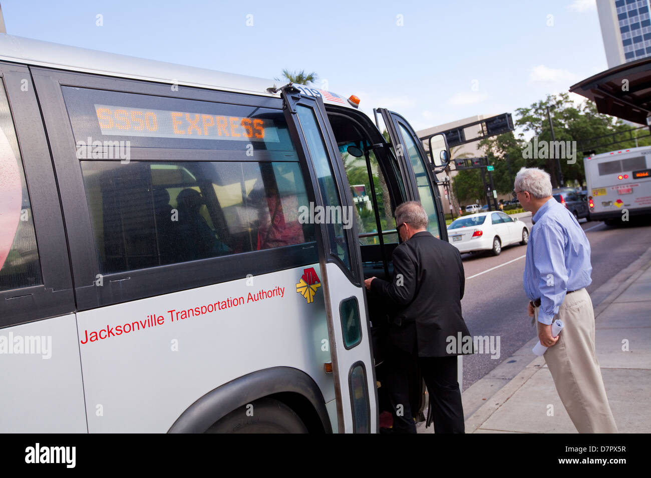 A men hops into a Jacksonville Transportation Authority bus is seen in Jacksonville, Florida Stock Photo