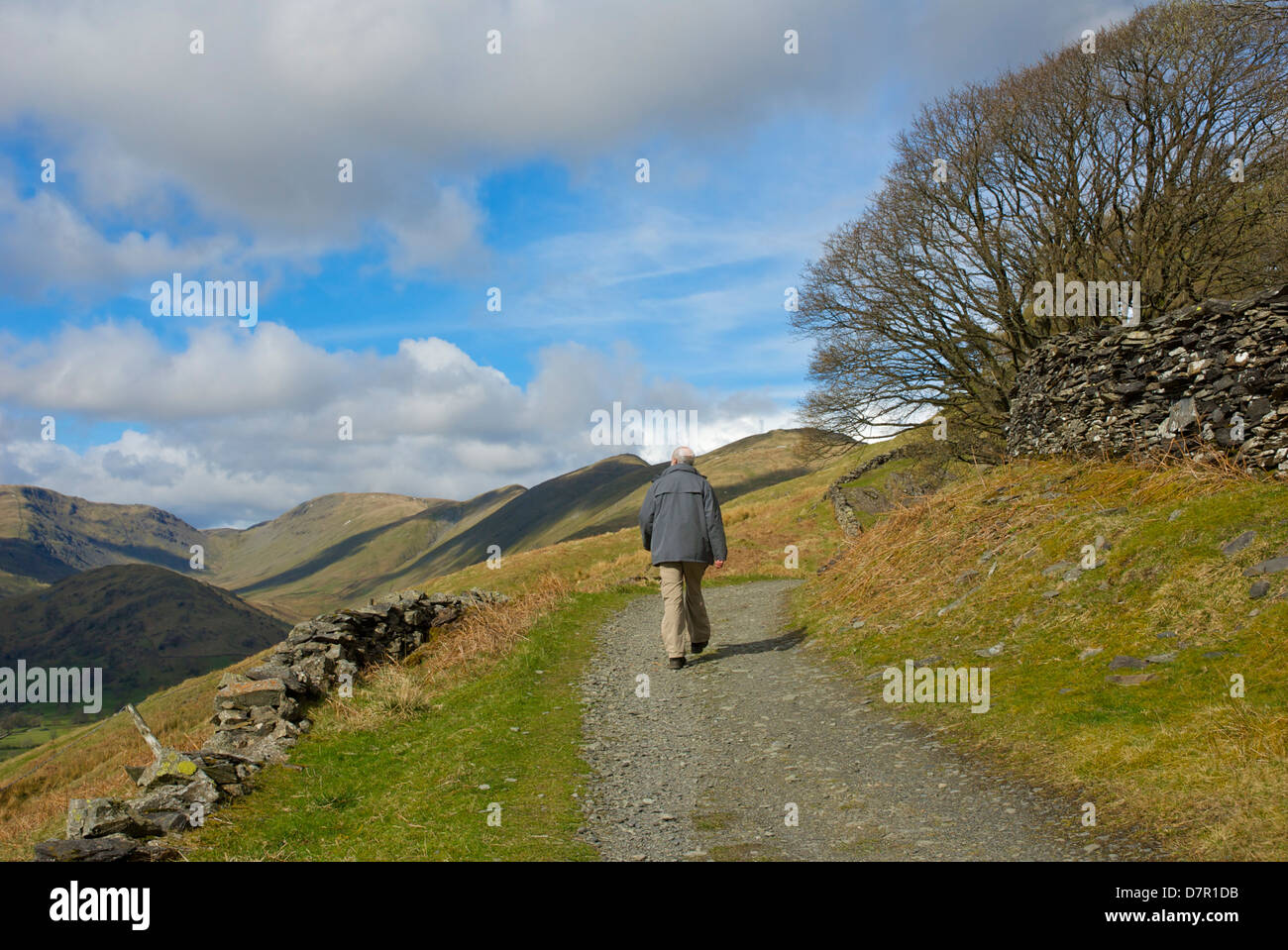 Senior walker on old track, Garburn Road, above the Troutbeck Valley, Lake District National Park, Cumbria, England UK Stock Photo