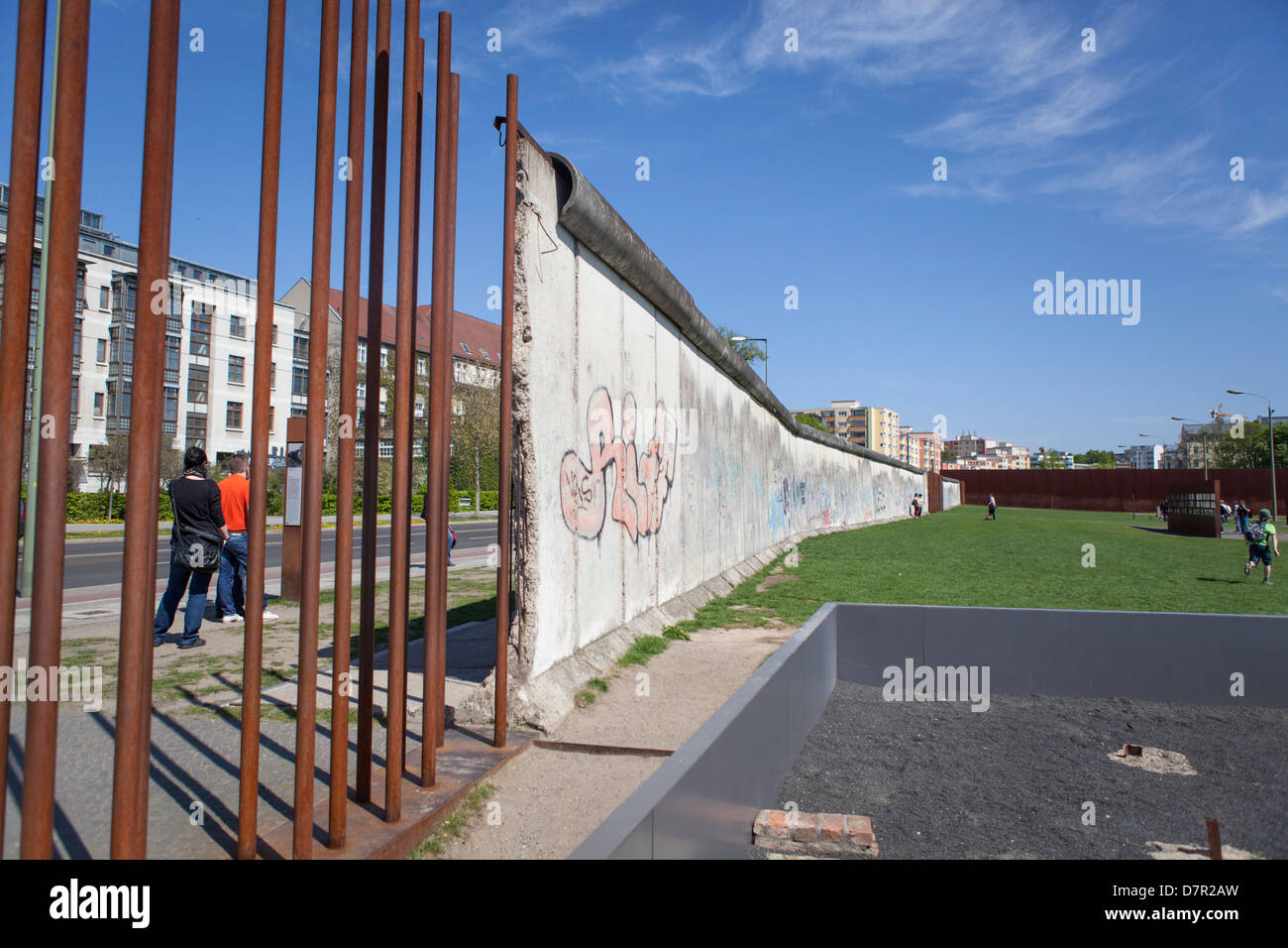 People passing the wall of Berlin at the Bernauer Strasse at the former WDR side Stock Photo