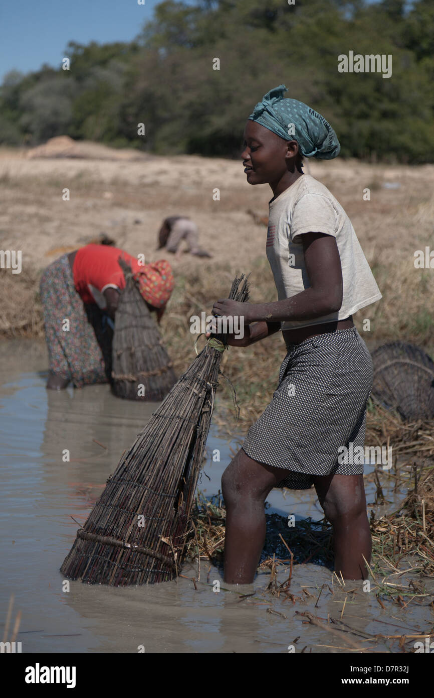African women fishing in a pond with children Stock Photo - Alamy