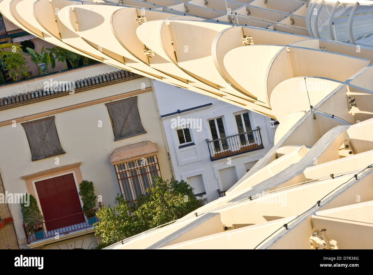 Traditional homes beneath the Metropol Parasol futuristic landmark Seville Andalusia Andalucia Spain Europe Stock Photo
