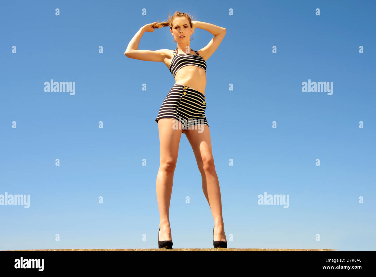 woman thinking , pulling her ponytail Stock Photo