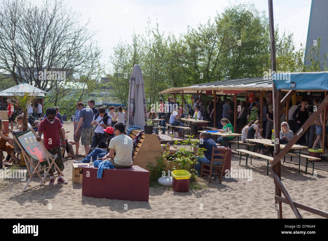 Young people enjoying the sun and a drink at the terrace of Yaam in Berlin. Stock Photo