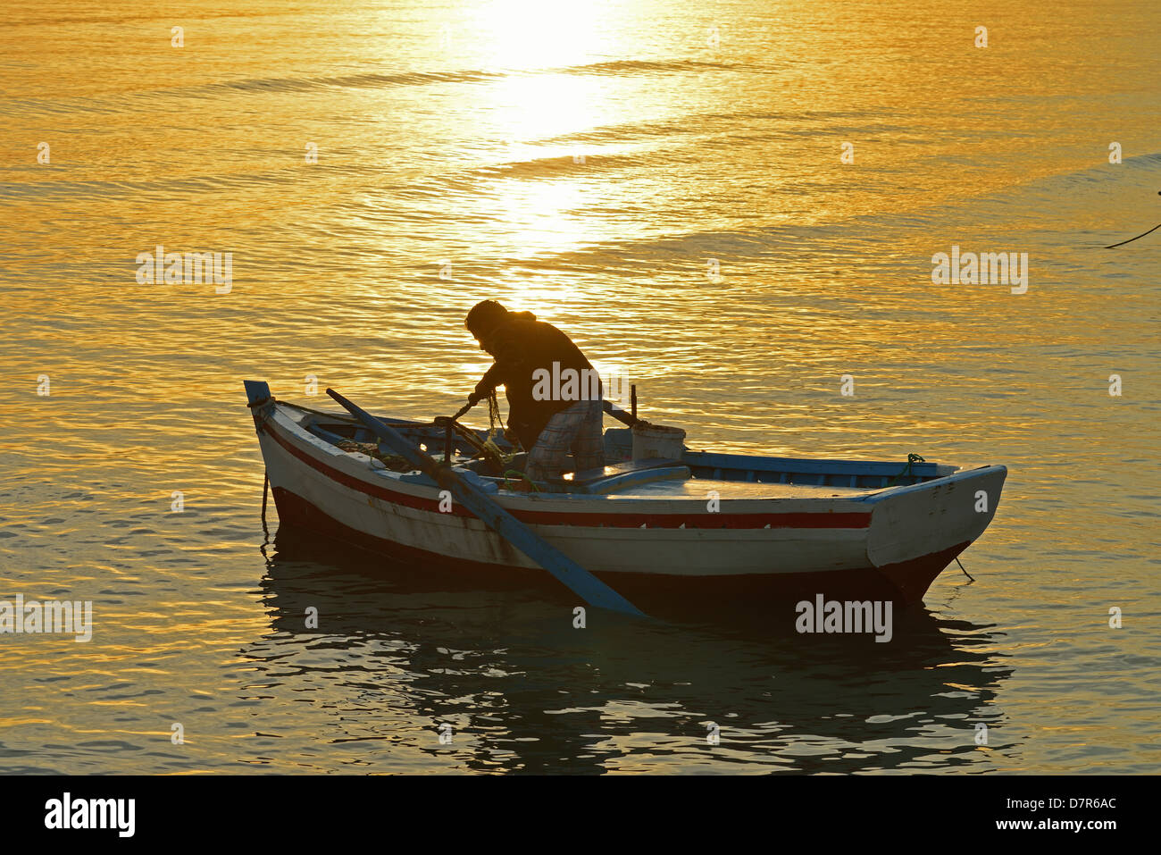Boat at sunrise, Mediterranean, Zarzis, Tunisia. Stock Photo